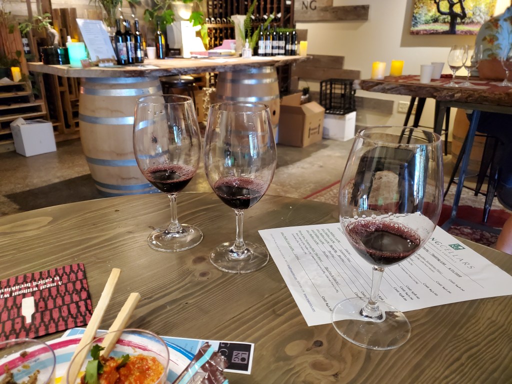 A flight of 3 wines ready for tasting.